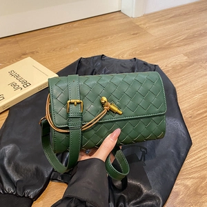 Handwoven deep green leather crossbody bag with square weave pattern and gold twist lock