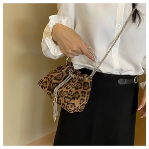 Detail of leopard print bucket bag with silver chain strap and tassel drawstring