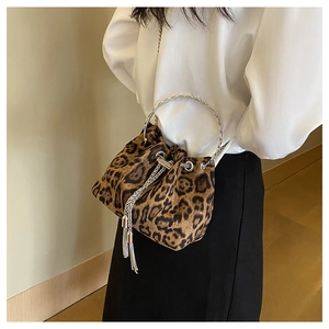 Detail of leopard print drawstring bucket bag with silver metal ring handle and fringe