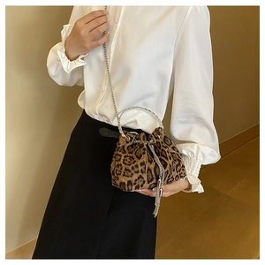 Leopard print bucket bag featuring a silver metal ring handle and chain strap for women