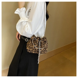 Close-up of leopard print bucket bag with silver chain strap and fringe tassel details