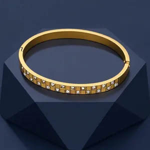 Golden double-row crystal stainless steel bangle with checkered pattern in a luxury setting