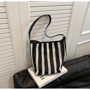 Detail of mesh tote bag with black and white stripes and sparkling rhinestone texture