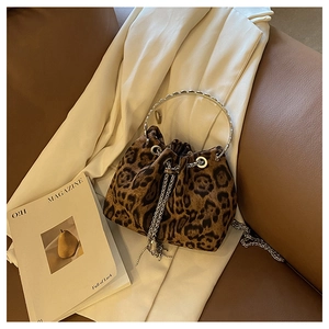 Detail of leopard print bucket bag with metal ring handle and drawstring tassels