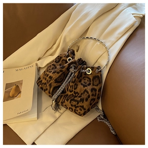 Close-up of leopard print bucket bag with metal ring handle and chain drawstring details