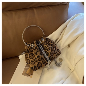 Detail of leopard print bucket bag with silver metal ring handle and tassel drawstring