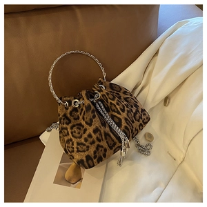Close-up of leopard print bucket bag with metal ring handle and silver chain detail