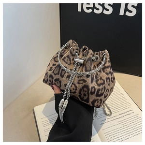 Detailed view of leopard print bucket bag with silver chain straps and tassel drawstring