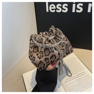 Close-up of leopard print bucket bag with silver chain handle and fringe tassels