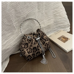 Detail of leopard print bucket bag with silver chain tassels and metal ring handle