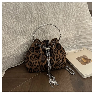 Detail of leopard print bucket bag with silver metal handle and tassel drawstring