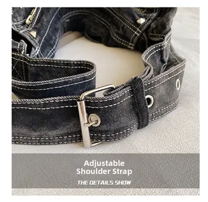Macro view of adjustable washed denim shoulder strap with silver buckle and white stitching