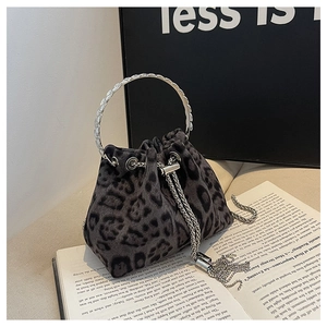 Detail of leopard print bucket bag with silver metal ring handles and tassel drawstring