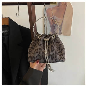Detail of leopard print bucket bag with silver metal ring handle and tassel drawstring