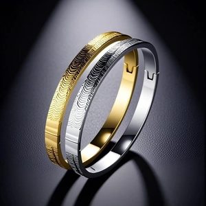 Detail of gold and silver stainless steel bangles with unique ripple textured engraving
