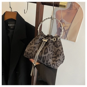Detail of leopard print bucket bag with silver metal ring handle and tassel drawstring