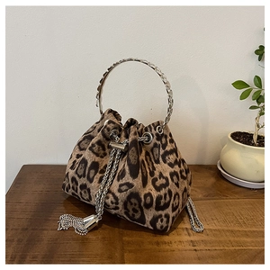 Detail of leopard print bucket bag featuring rhinestone tassels and silver chain straps