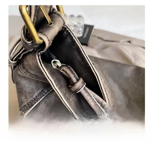 Detailed macro view of the vintage washed PU leather bag showing smooth metal zipper