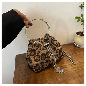 Detail of leopard print bucket bag with silver ring handle and chain drawstring