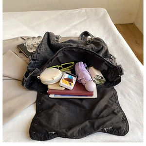 Large capacity washed denim tote bag interior showing organized daily essentials and space