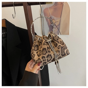 Detail of leopard print velvet bucket bag with metal chain drawstring and handle