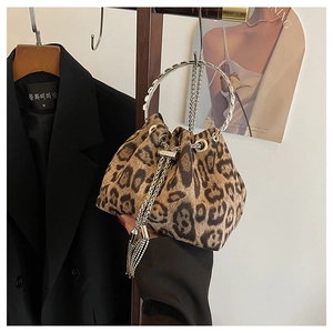 Detail of leopard print bucket bag with silver metal handle and long chain tassels