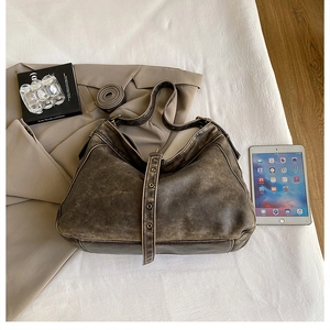 Close-up of vintage large brown PU leather tote bag with iPad for size reference