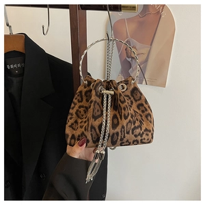 Detail of leopard print bucket bag featuring large silver ring handle and chain drawstrings