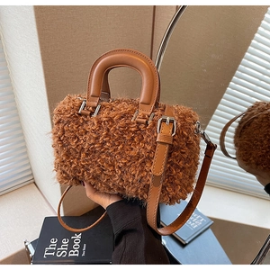 Close-up of caramel plush faux fur texture and leather handle on the Boston bag