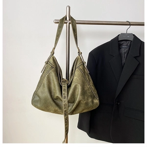 Detail of army green hobo bag featuring vintage washed PU leather and adjustable strap