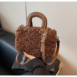 Detail of plush brown teddy texture and silver hardware on a crossbody Boston bag