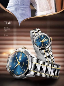 Close-up of luxury couple watches with blue sunray dials and diamond hour markers