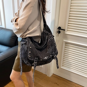 Distressed black denim tote bag with silver studs and punk eye embroidery detail