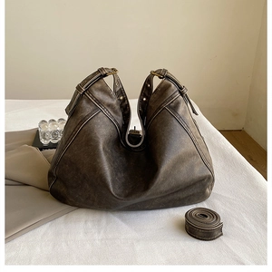 Detail of vintage coffee PU leather hobo bag showing supple texture and adjustable strap