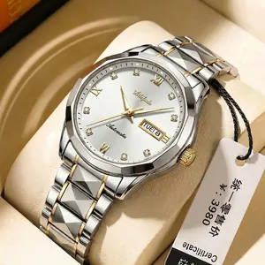 Detail of two-tone stainless steel watch with white dial in luxury box