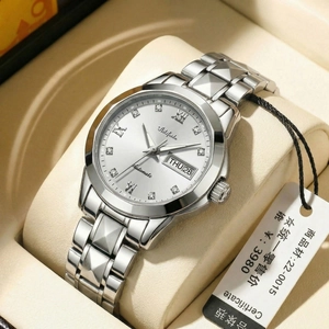 Detail of silver steel watch dial showing date-day display and roman numeral markers