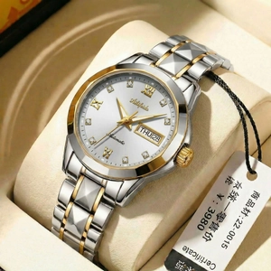 Close-up of women's dual-tone steel watch with Roman numerals and day-date display