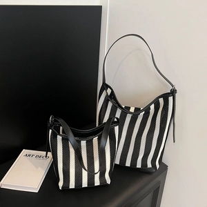 Black and white striped mesh tote bag set with leather handles and zip closure