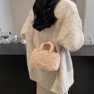 Stylish plush faux fur Boston bag for women with leather handles and crossbody strap