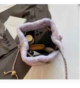 Top view of plush bucket bag showing spacious interior with phone and wallet inside
