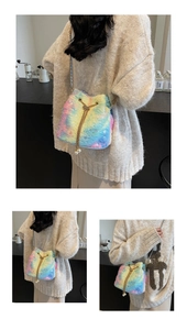 Detail of colorful plush bucket bag with golden chain and pearl drawstring charms