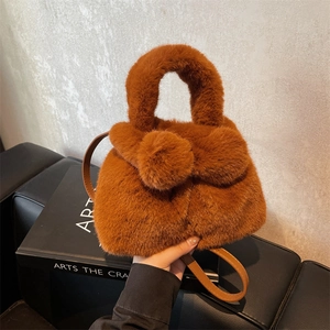 Cute brown plush bunny bucket bag with furry pom-poms and adjustable strap