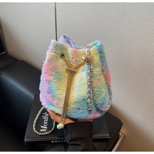 Detail of colorful plush bucket bag featuring soft rainbow faux fur and pearl drawstring