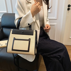 Minimalist bicolor canvas and leather handbag for commuting with adjustable strap
