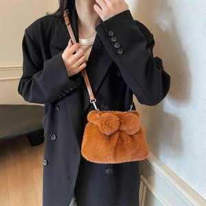 Cute plush rabbit bucket bag in caramel brown faux fur with decorative pom-poms