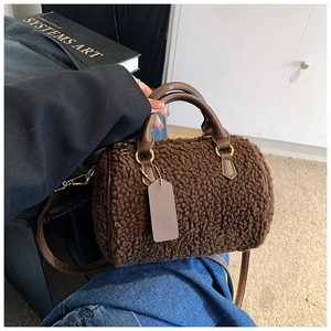 Detailaufnahme der braunen Fleece Boston Bag mit Ledergriffen und Gold-Metall-Akzenten