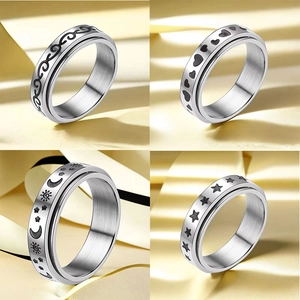 Detail of spinner rings with moon, star and heart motifs on champagne silk