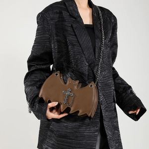 Brown bat-shaped crossbody bag with silver cross detail and chain strap for women