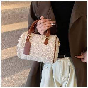Detail shot of the plush sherpa texture and brown leather trim on the Boston handbag
