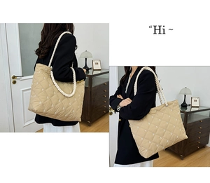Detail of khaki quilted tote bag featuring thick white cotton rope shoulder straps